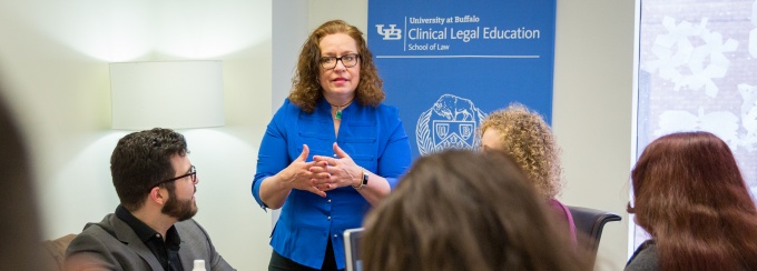 Picture of Professor Kim Connolly teaching a clinical course to a small group of law students. 