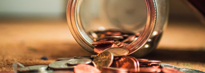 jar of coins spilled out on the counter. 