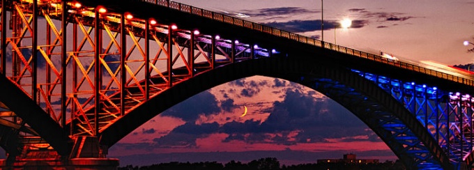 Peace bridge uniting the United States and Canada at moonrise. 