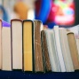 Close up image of a row of books on a shelf. 