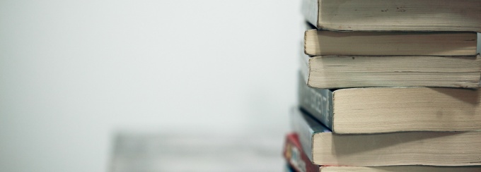 a stack of large books on a table. 