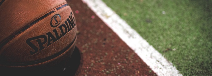 photo of a basketball on the ground of a basketball court. 