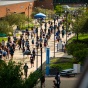 a group of students walking on campus. 