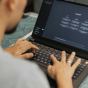 Person using a laptop displaying an AI chatbot interface. 