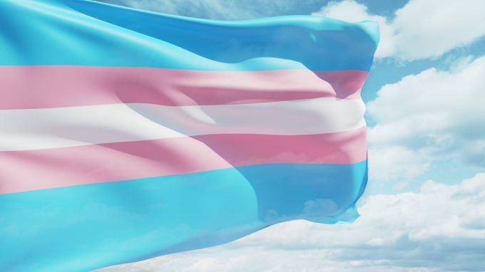 Transgender flag waving in the sky. 