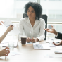 group of diverse people sitting around a table having an intense conversation. 