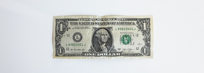 photo of a dollar bill on a white background. 