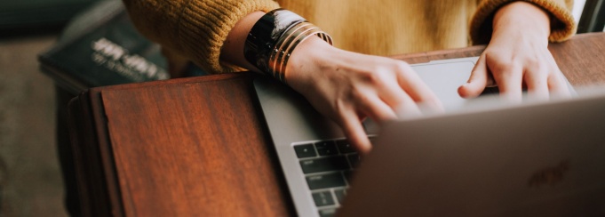 close up of hands typing on a laptop. 