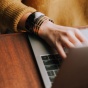 close up of hands typing on a laptop. 