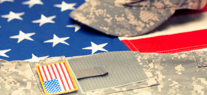 American flag with military cap and jacket. 