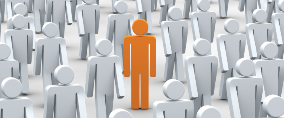 Orange figure highlighted among gray figures, symbolizing an applicant who stands out beyond traditional admissions metrics. 