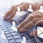 Hands typing on a laptop keyboard with digital icons overlaid, including multiple user profile symbols connected by lines and a large envelope icon, representing email communication and networking. 