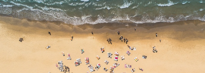 birds eye view of people sitting on a beach. 