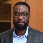 man wearing glasses and suit. 