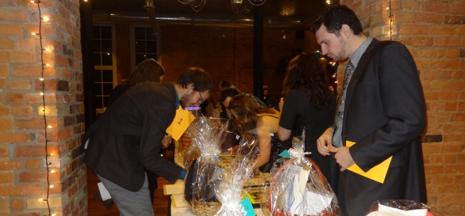 Auction attendees looking over donated items on which they would like to bid. 