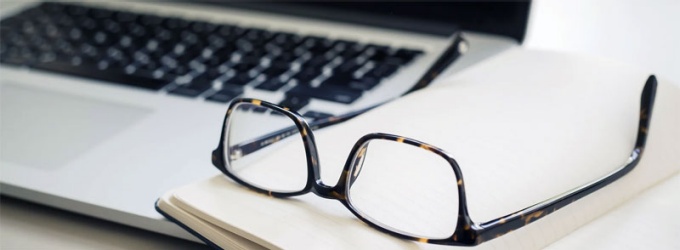 photo of reading glasses on a book. 