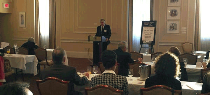 speaker conducting a lecture at a podium. 