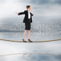 woman walking a tightrope. 