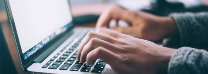 person typing on a computer. 