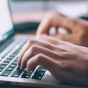 person typing on a computer. 