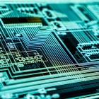 photo of a glowing computer circuit board. 