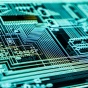 photo of a glowing computer circuit board. 