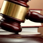 gavel with a book in the background. 