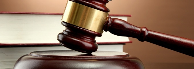 a brown gavel and books on a table. 