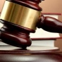 wooden gavel in front of books on a desk. 