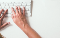 hands typing on a keyboard. 