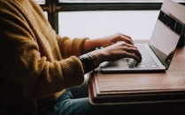 person typing on a laptop computer. 