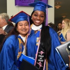 two young women celebrating their graduation. 