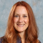 Julie Jones wearing blue shirt, smiling. 