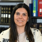 Lellis sitting at a table in the Law Library. 