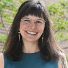 Wilson standing outside next to O'Brian Hall. 