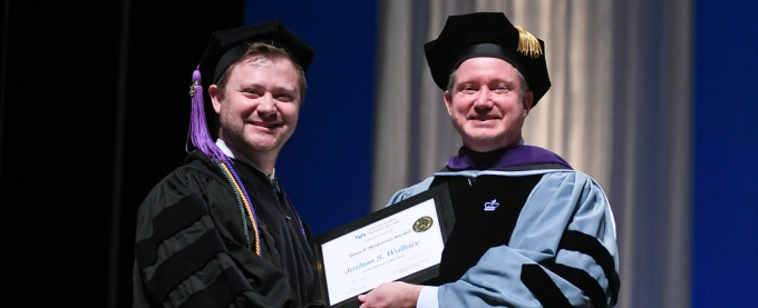 Joshua Wallace receiving award from Todd Brown. 