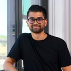 Raad Ahmed standing next to a window. 