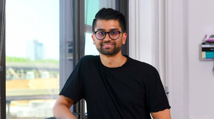 Raad Ahmed standing next to a window. 