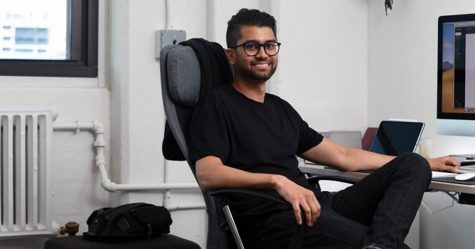 Rad Ahmed sitting in a chair. 