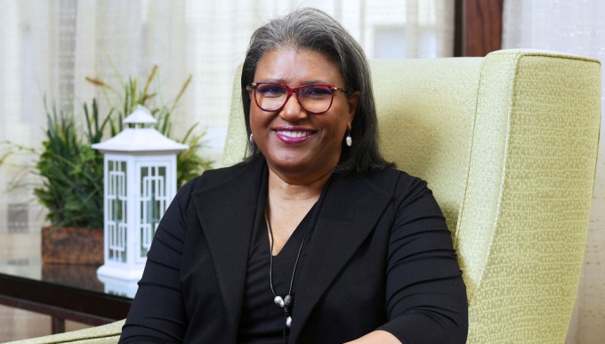 photo of Vikki Pryor sitting on a chair. 