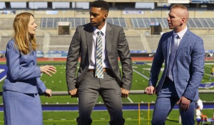 Nellie Drew with law students in a football stadium. 