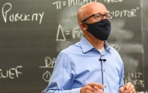 photo of professor bartholomew teaching a class while wearing a protective mask. 