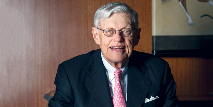 Tom Beecher sitting in a chair in his office. 