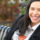 Talia Rodriguez sitting on a bench, smiling. 