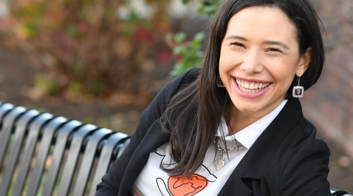 Talia Rodriguez sitting on a bench, smiling. 