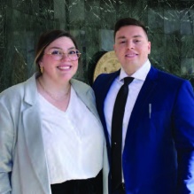 man and women standing inside a courthouse. 