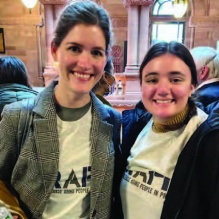 two women, smiling. 