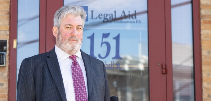man standing outside the Legal Aid window. 