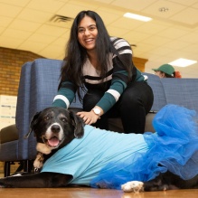 female student petting a dog. 
