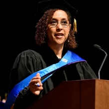 woman speaking at a podium. 